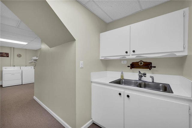 interior space featuring carpet flooring, cabinets, sink, and washer and dryer