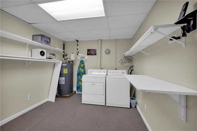 clothes washing area featuring electric water heater, light carpet, and washer and dryer