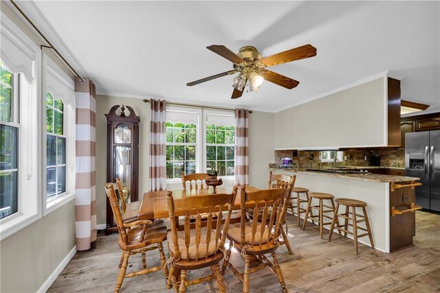 dining room with a wealth of natural light, ceiling fan, light wood-type flooring, and ornamental molding