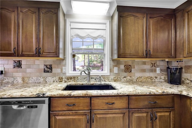 kitchen with stainless steel dishwasher, light stone countertops, sink, and decorative backsplash