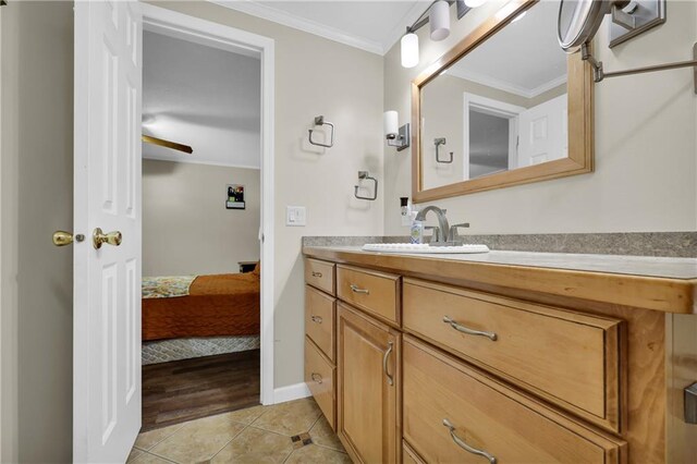 bathroom with ornamental molding, vanity, and tile patterned floors