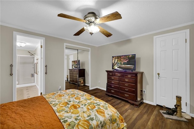 bedroom with ensuite bath, ornamental molding, ceiling fan, dark hardwood / wood-style floors, and a closet