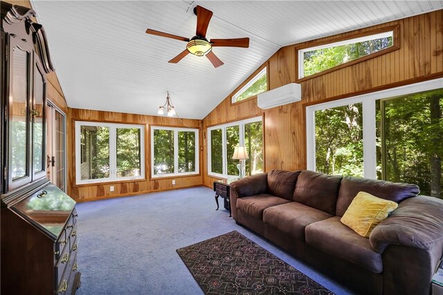 sunroom / solarium featuring a wealth of natural light, lofted ceiling, a wall unit AC, and ceiling fan