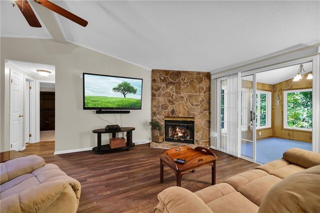 living room featuring a fireplace, hardwood / wood-style flooring, ceiling fan, and vaulted ceiling