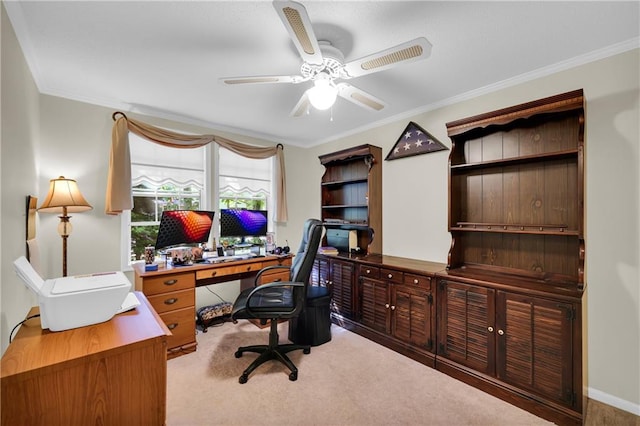 carpeted home office featuring ceiling fan and crown molding