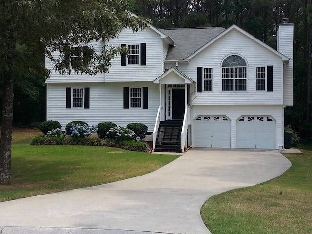 view of front facade featuring a chimney, roof with shingles, a front yard, concrete driveway, and an attached garage