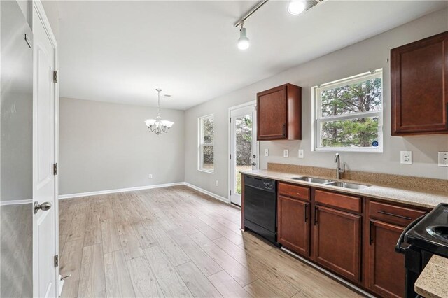 kitchen with black appliances, light countertops, a sink, and light wood-style flooring