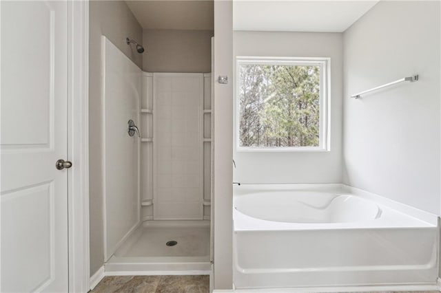 full bath with a shower and a garden tub