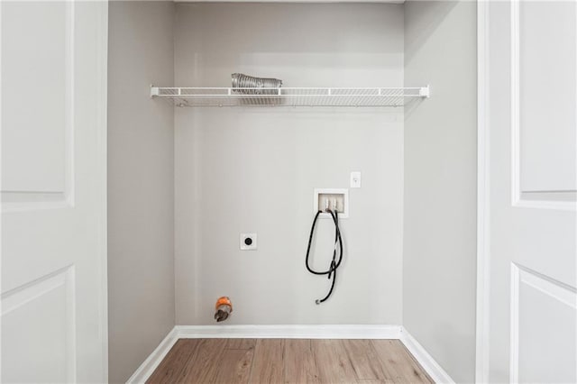 laundry area featuring laundry area, baseboards, wood finished floors, washer hookup, and electric dryer hookup