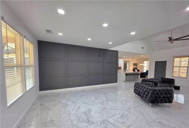 living room featuring vaulted ceiling and ceiling fan