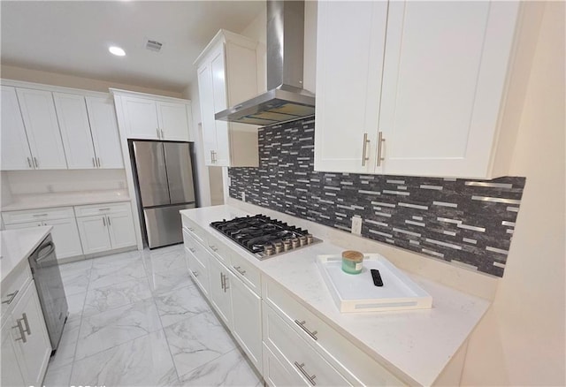 kitchen with white cabinetry, stainless steel appliances, backsplash, and exhaust hood