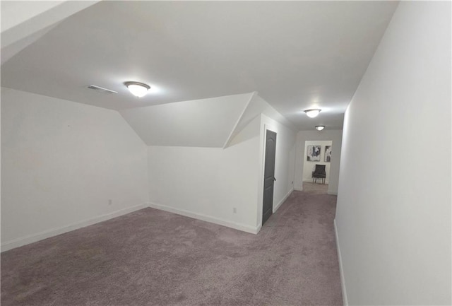 additional living space with lofted ceiling and light carpet