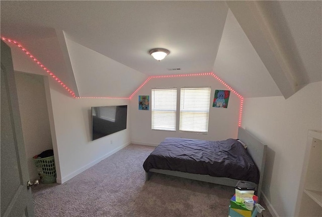 bedroom featuring lofted ceiling and carpet floors