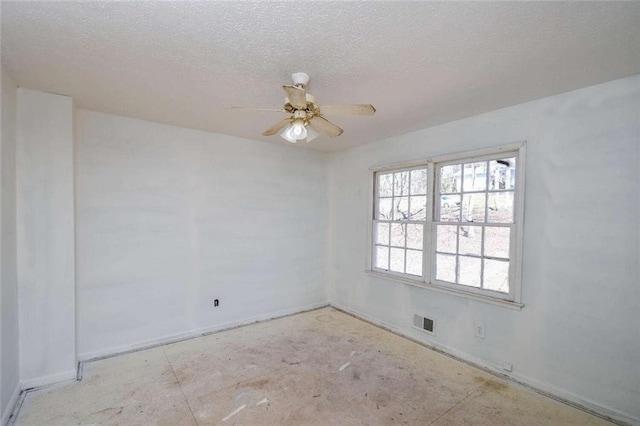 unfurnished room featuring ceiling fan, visible vents, and a textured ceiling