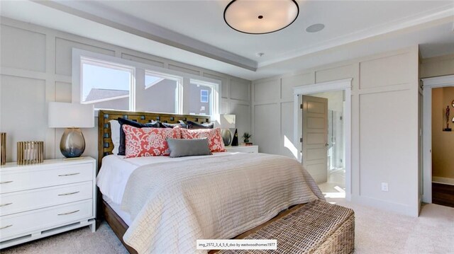 bedroom featuring connected bathroom and light carpet