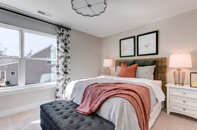 bedroom featuring light colored carpet