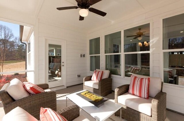 sunroom featuring ceiling fan