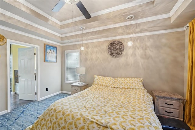 bedroom with baseboards, a raised ceiling, and crown molding