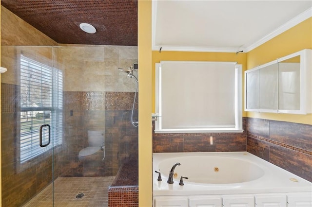 bathroom with a garden tub, a shower stall, and ornamental molding