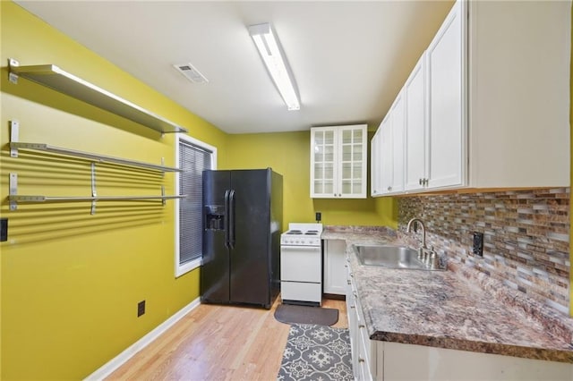 kitchen with white range with electric cooktop, black refrigerator with ice dispenser, glass insert cabinets, white cabinets, and a sink