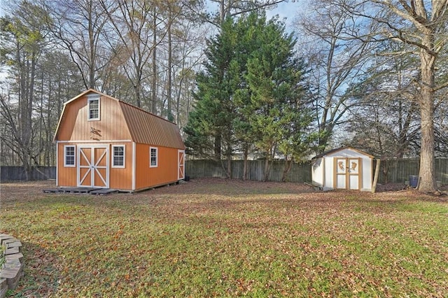 view of yard with an outbuilding, a fenced backyard, and a storage unit