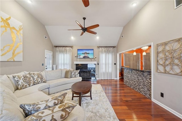 living area with visible vents, high vaulted ceiling, dark wood-style flooring, and a ceiling fan