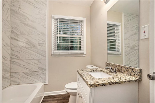 2791 Mcafee Rd, Decatur, GA 30032 - full bathroom featuring wood-type flooring, vanity, toilet, and tiled shower / bath combo