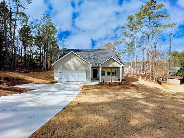 view of front of house featuring a porch, driveway, and a garage