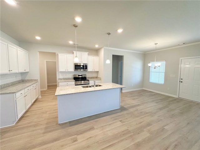 kitchen featuring tasteful backsplash, light wood-style flooring, appliances with stainless steel finishes, and a sink