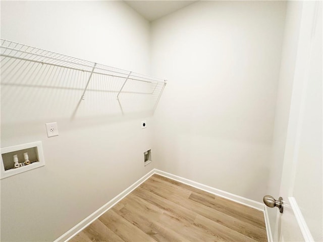 washroom featuring baseboards, laundry area, hookup for a washing machine, light wood-style floors, and hookup for an electric dryer