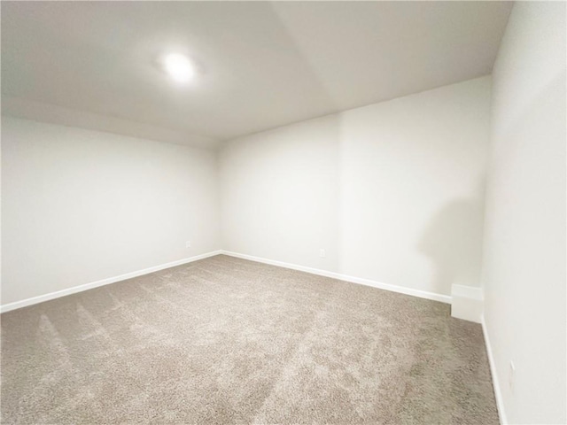 unfurnished room with baseboards and carpet