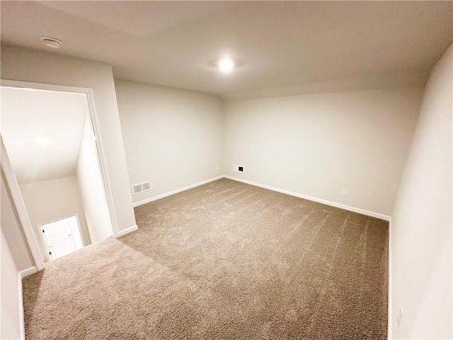 spare room featuring baseboards, visible vents, and carpet floors