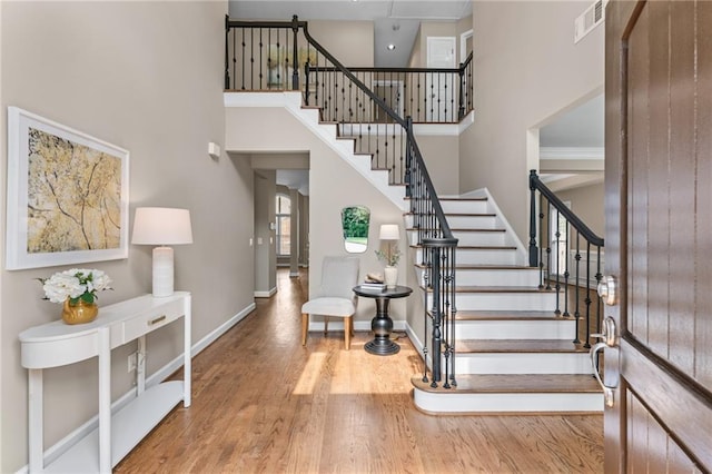 4648 Glenshire Pl, Atlanta, GA 30338 - staircase with a towering ceiling, baseboards, and wood finished floors