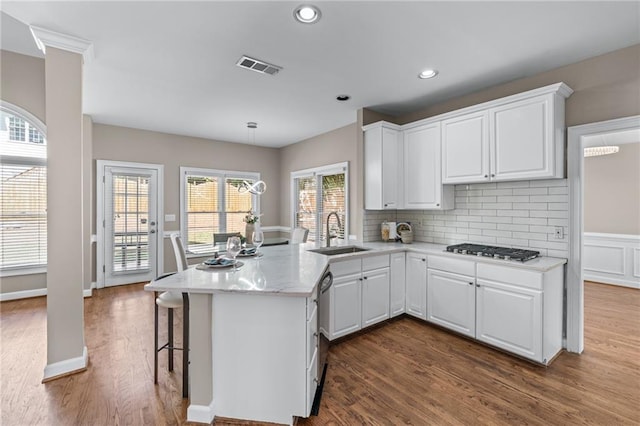 4648 Glenshire Pl, Atlanta, GA 30338 - kitchen with a sink, stainless steel appliances, a peninsula, white cabinetry, and dark wood finished floors