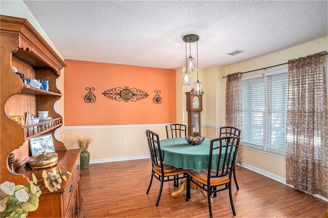 2130 Hampton Trl SE, Conyers, GA 30013 - dining room with wood finished floors and a textured ceiling
