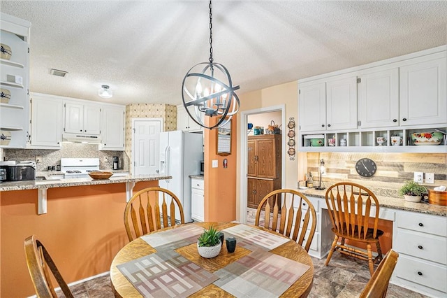 2130 Hampton Trl SE, Conyers, GA 30013 - dining area with a chandelier and a textured ceiling