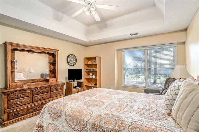 2130 Hampton Trl SE, Conyers, GA 30013 - carpeted bedroom with a tray ceiling and a ceiling fan