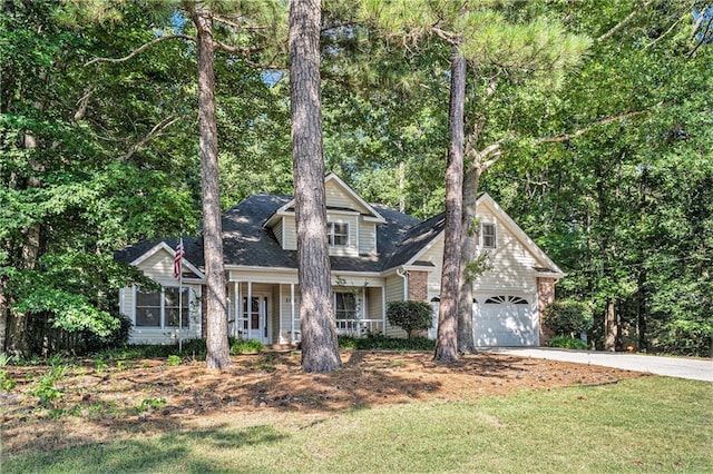 2130 Hampton Trl SE, Conyers, GA 30013 - view of front of home with concrete driveway, covered porch, an attached garage, and a front yard