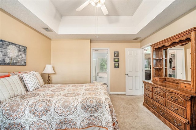 2130 Hampton Trl SE, Conyers, GA 30013 - bedroom featuring light colored carpet, a tray ceiling, a ceiling fan, and connected bathroom