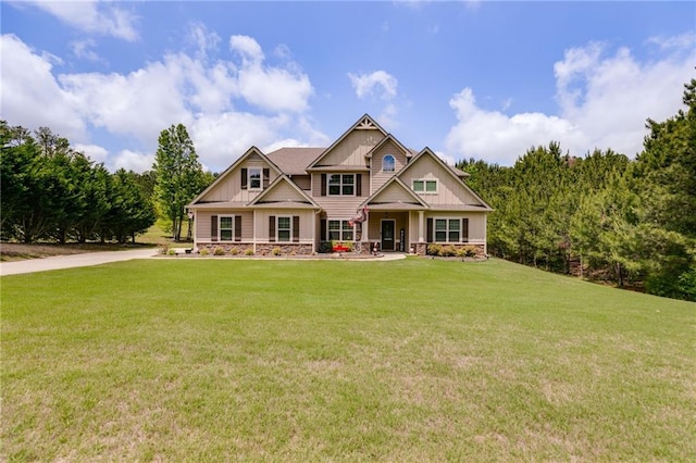 craftsman inspired home featuring board and batten siding, a front lawn, and stone siding