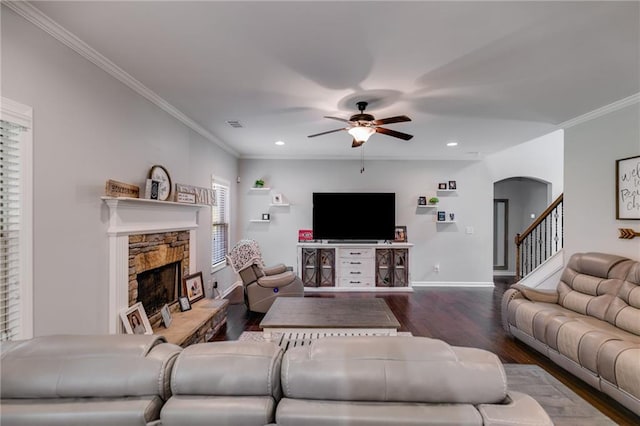 living room with a ceiling fan, wood finished floors, a stone fireplace, recessed lighting, and baseboards