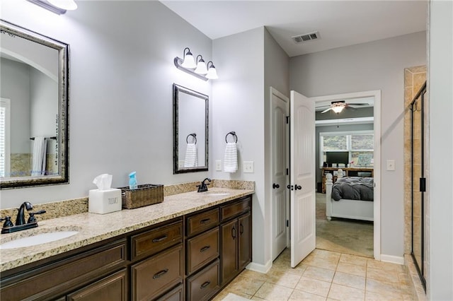 full bath with tile patterned floors, a shower stall, connected bathroom, a ceiling fan, and double vanity