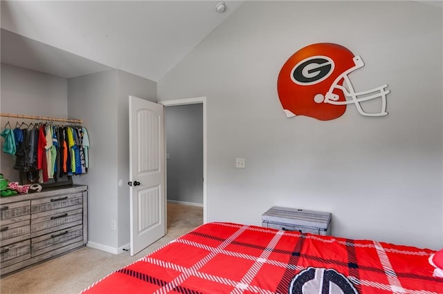 carpeted bedroom featuring lofted ceiling and baseboards