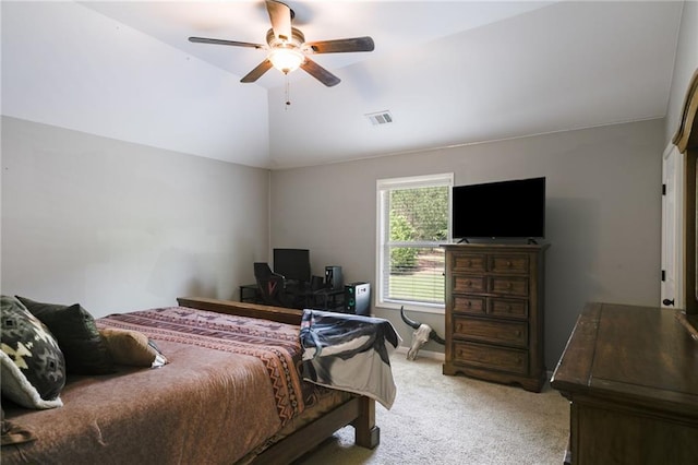 bedroom featuring light carpet, vaulted ceiling, and a ceiling fan