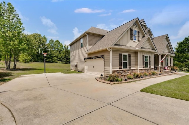 view of property exterior with board and batten siding, concrete driveway, a lawn, and a shingled roof