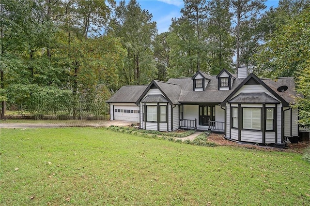 exterior space featuring a garage, a front lawn, driveway, and a chimney