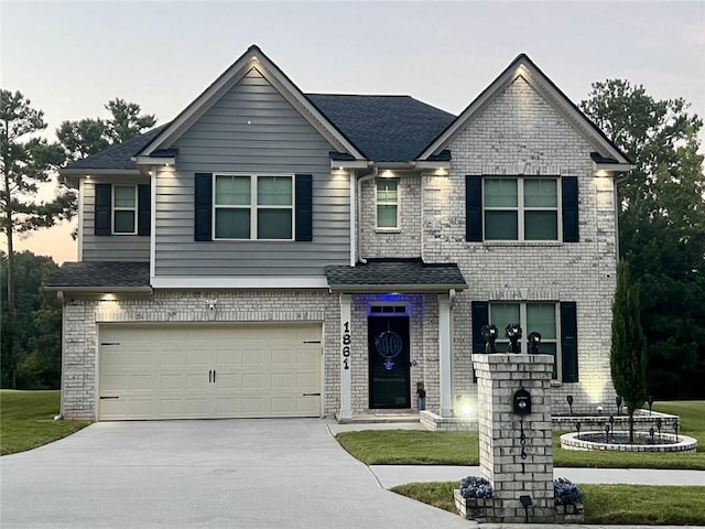 view of front facade featuring brick siding, an attached garage, and driveway