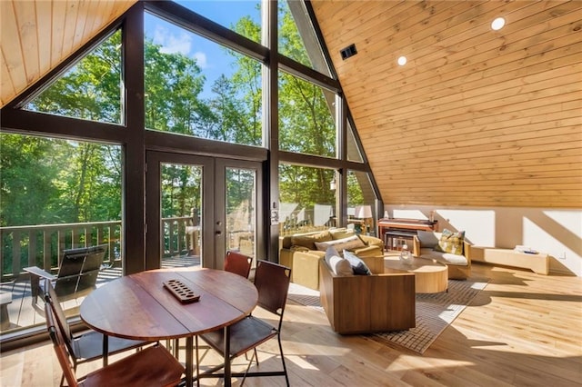 sunroom with wood ceiling, vaulted ceiling, french doors, and plenty of natural light