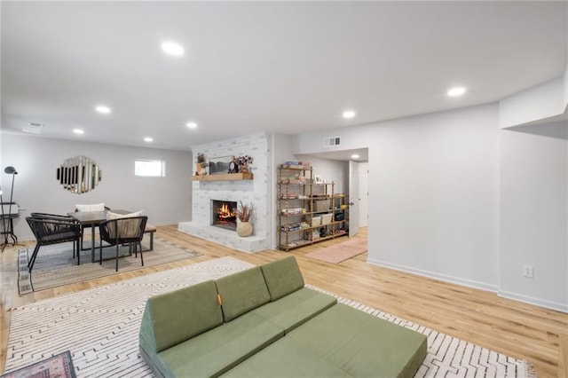 living room featuring a fireplace and hardwood / wood-style floors