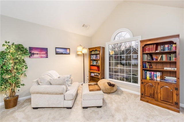 sitting room with high vaulted ceiling, baseboards, visible vents, and carpet flooring